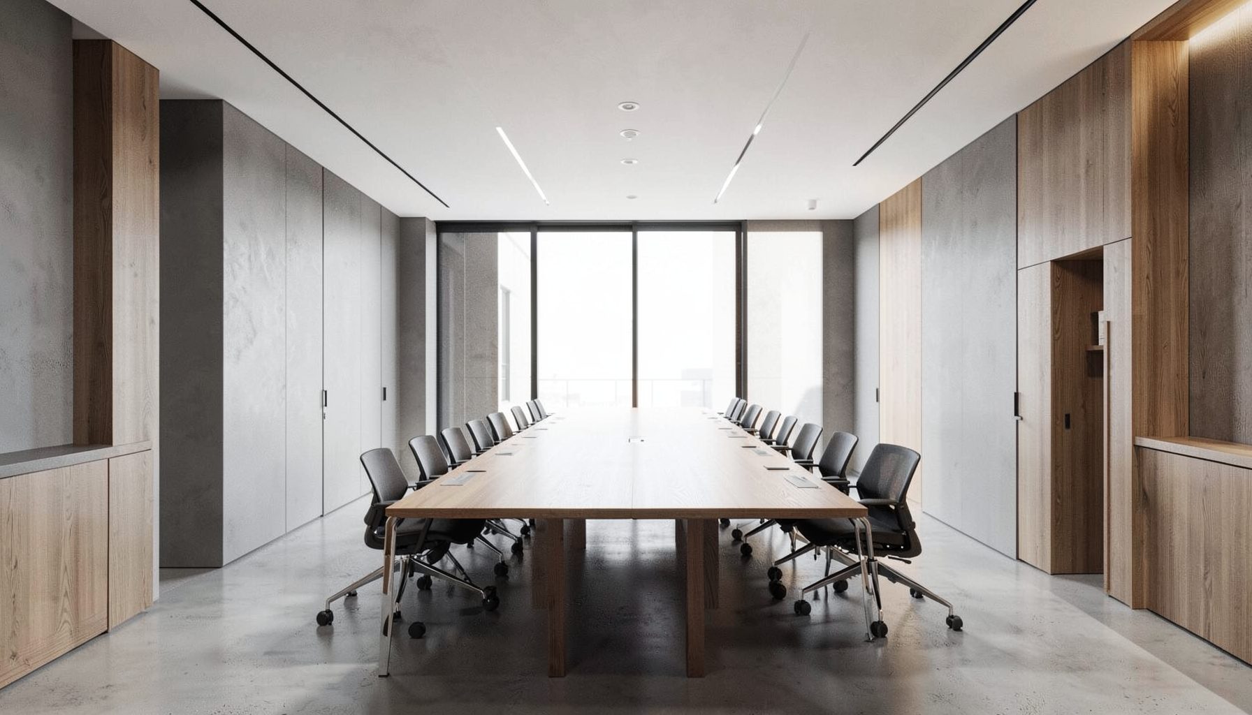 Clean architectural photograph of a modern office interior with strong symmetry, featuring a long communal table, muted gray walls, warm wood accents, and soft natural light from large windows.